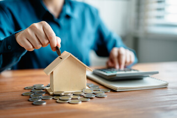 woman hand putting money coins into housing for fund, .planning saving money wealth to planning...