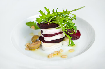Gourmet beet and goat cheese salad on white plate