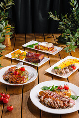 Gourmet feast: variety of dishes on wooden table