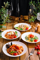 Assorted italian pasta dishes on wooden table