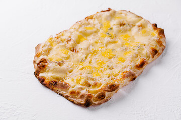 Delicious cheesy flatbread on white background