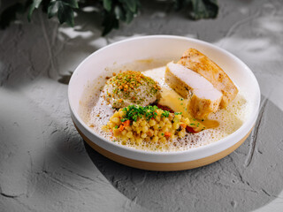 Gourmet chicken dish with couscous and foam
