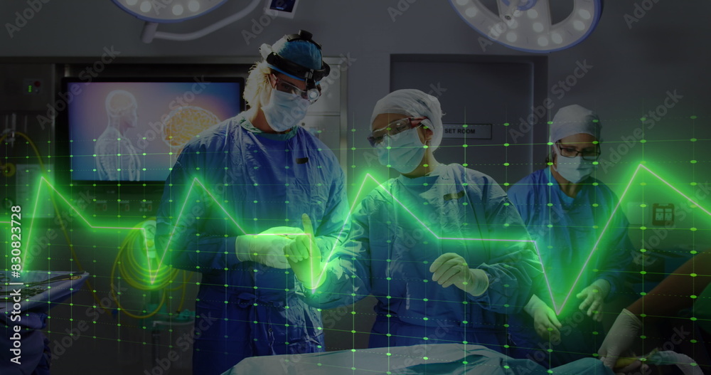 Wall mural Image of heart rate monitor against diverse male and female surgeons discussing before surgery