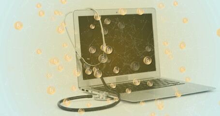 Image of bitcoin symbols against laptop and stethoscope against grey background