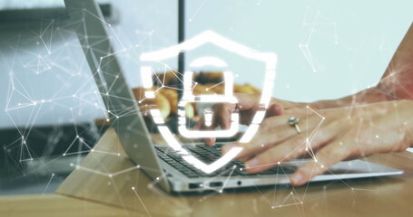 Image of security padlock icon against mid section of a woman using a laptop at office