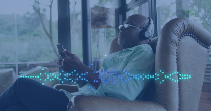 Image of music data processing over african american man with headphones