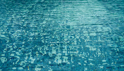 Water surface texture sunlight reflection blue wave background,Swimming pool bottom caustics ripple...