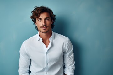 Fototapeta premium Portrait of a handsome young man in a white shirt. Men's beauty, fashion.