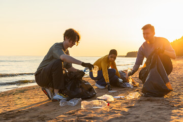 Earth day. Volunteers activists team collects garbage cleaning of beach coastal zone. Woman mans...