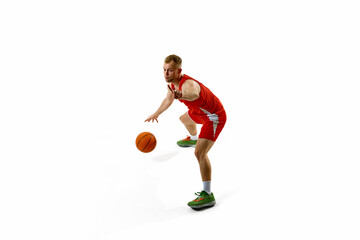 Portrait of young man, basketball player in red athletic gear preparing for maneuver or shot...