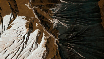 Aerial of wide gorge with rocky cliffs from both sides of small canyon. Clip. Stone slopes and...