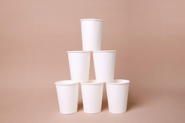 Creativity Of Blank White Cup Arrangement Isolated On Beige Background