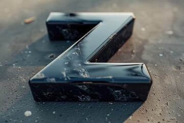Detailed shot of a black letter on a wet surface, suitable for various design projects