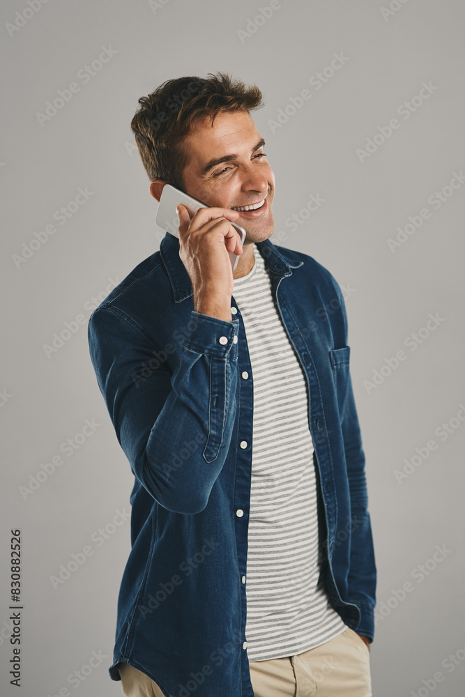 Poster Studio, man and phone call with smile, funny news and comedy with contact. Creative worker, conversation and networking on smartphone with humor, chatting and connection by gray background with pride