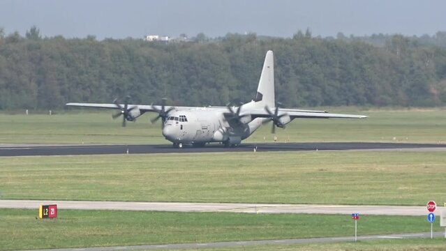 Generic Military Army Transport airplane taxiing on the runway prior take off for a mission evacuation