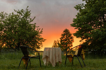 garden furniture table and chairs in the garden at sunset