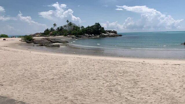 Sungailiat, Bangka Belitung 15 April 2024, Parai Beach, 
calm beach atmosphere and small waves, with a stretch of clean white sand and rocks