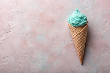 Sweet dessert. A stylish modern concept. Turquoise ice cream cone on a pink background. World Ice Cream Day.