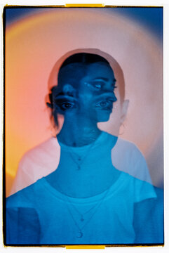 Multiple exposure of woman against colored background