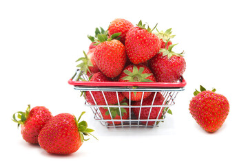 Shopping supermarket basket with fresh organic ripe strawberries whole and heap isolated on a white background. Purchase of products. Agricultural products and harvesting.