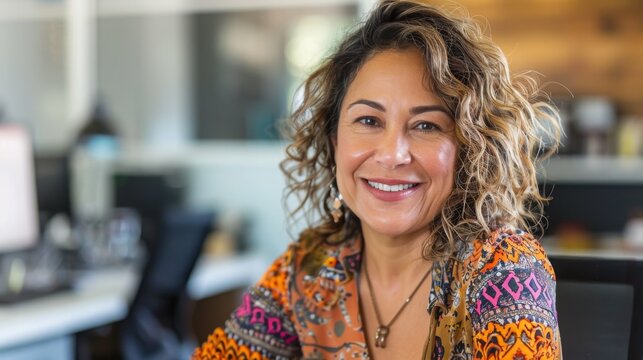 Confident Middle-Aged Hispanic Woman Smiling in Colorful Blouse in Modern Office Setting, Professional Portrait