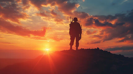 Fototapeta premium Silhouette of a soldier with sunset on a Hill