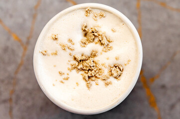 halva on a frothy beverage raf coffee in a white ceramic cup