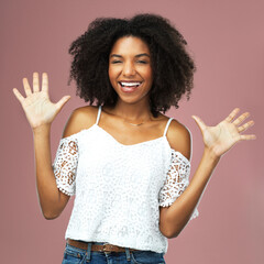 Portrait, hands and excited woman in studio for wave, greeting and happiness on pink background....
