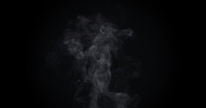 White natural rising steam from food or hot drink isolated on a black background.