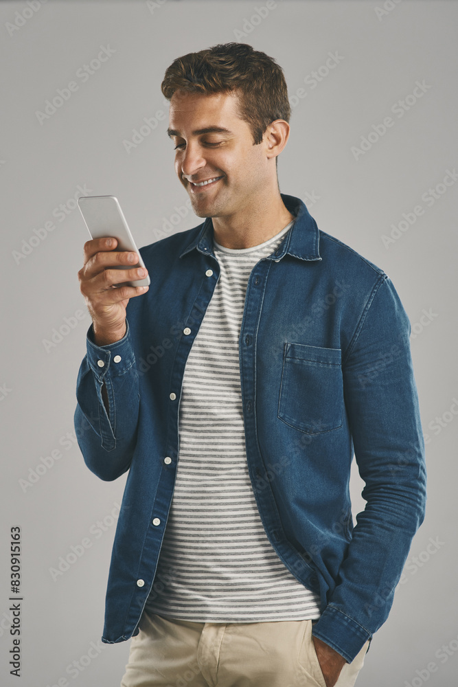 Poster Studio, man and smartphone for chatting, networking and funny news with contact on social media. Creative worker, scroll and browse on dating app with humor, text and connection by gray background