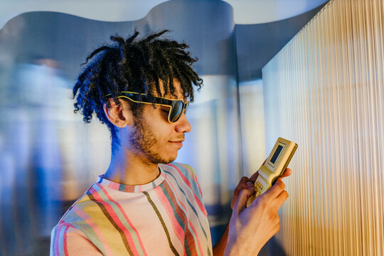Young man with dreads playing video game