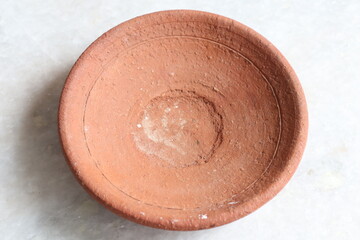 Handmade terracotta clay plate isolated on White Background