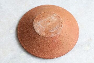 Handmade terracotta clay plate isolated on White Background
