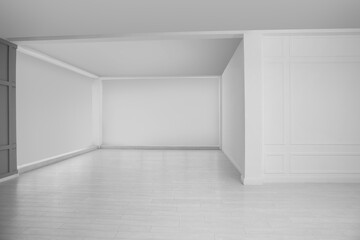 Empty room with white walls and laminated floor