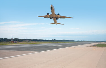 White Passenger plane fly up over take-off runway from airport - Barcelona, Spain