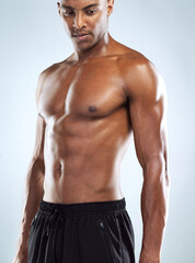 Fototapeta premium African, man and topless as body builder in white background for fitness, health and wellness in studio. Black. male person and pride with muscle for training, workout and results with confidence