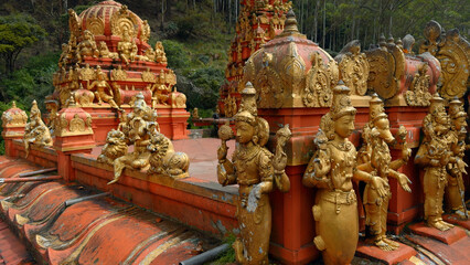 Malaysian temple with golden statues of the saints. Action. Concept of religion and culture.