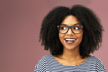 Glasses, thinking and excited black woman with idea, vision or planning isolated on pink studio...