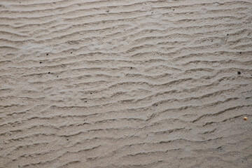 waves texture on beach sand at low tide