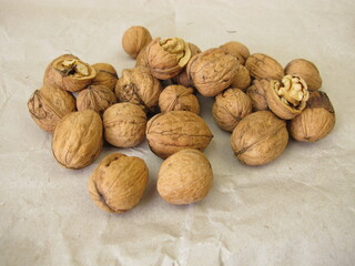 Walnuts of various sizes from different trees spread out on paper to dry