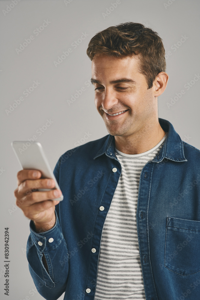 Poster Studio, man and cellphone for chatting, networking and funny news with contact on social media. Creative worker, scroll and browse on dating app with humor, text and connection by gray background