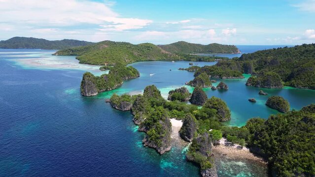 Raja Ampat, Indonesia: Aerial drone footage of the Piaynemo viewpoint famous for its limestone karst landscape in Raja Ampat archipelago in West Papua in Indonesia. 