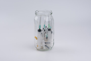 Used syringes are on glass bottle 