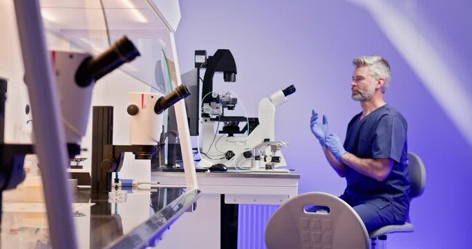 Embryologist performing artificial fertilization of a human egg in a laboratory, using advanced microscope technology. IVF process in a modern lab setting. In vitro fertilization, egg freezing.