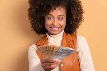 fun african american woman celebrating successful business Brazil money in studio shot. business,...