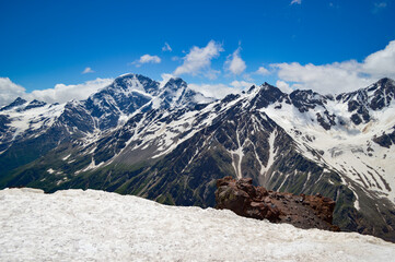 Beautiful peaks of the Western Caucasus on a sunny summer day. Mountains covered with snow and...