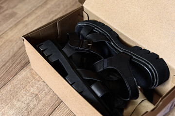 Unpacking box of new women's sandals.