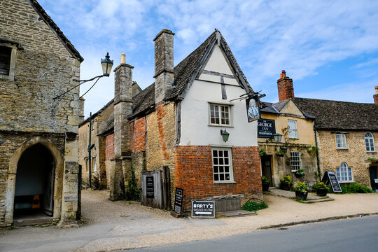 Lacock, Wiltshire, Cotswolds, England, UK - 08.04.2024. The George Inn pub. Historic and well preserved village of Lacock, in county Wiltshire is popular tourist stop. The medieval village of Lacock
