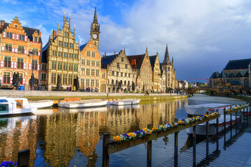 Scenic view of the historical city center of Ghent (Gent), Belgium. Beautiful cityscape with medieval architecture, monumental landmarks and Lys river with tourist boats, outdoor travel background