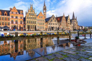 Scenic view of the historical city center of Ghent (Gent), Belgium. Beautiful cityscape with medieval architecture, monumental landmarks and Lys river with tourist boats, outdoor travel background